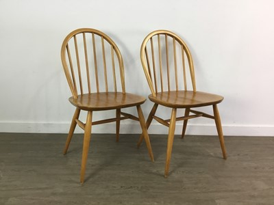 Lot 410 - AN ERCOL ELM AND BEECH DROP LEAF DINING TABLE AND FOUR CHAIRS