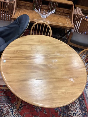 Lot 410 - AN ERCOL ELM AND BEECH DROP LEAF DINING TABLE AND FOUR CHAIRS