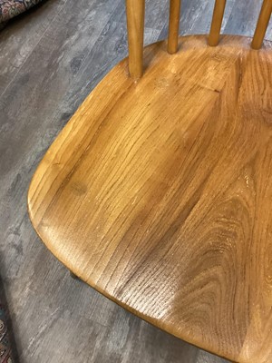 Lot 410 - AN ERCOL ELM AND BEECH DROP LEAF DINING TABLE AND FOUR CHAIRS