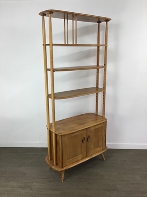 Lot 412 - AN ERCOL 'GIRAFFE' GOLDEN ELM DISPLAY UNIT