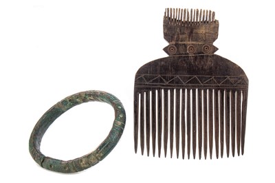 Lot 45 - AN AFRICAN IGBO CURRENCY BANGLE AND A TRIBAL WOODEN COMB