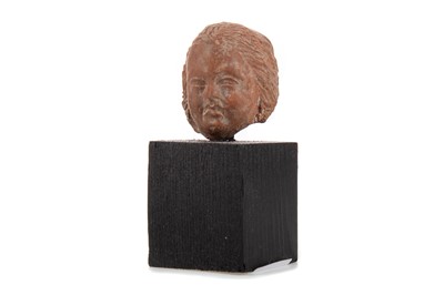 Lot 35 - A SMALL ROMAN POTTERY PUTTO BUST
