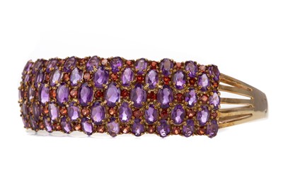 Lot 661 - A GARNET AND AMETHYST CUFF