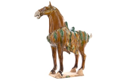 Lot 1265 - A CHINESE TANG-STYLE SANCAI GLAZED POTTERY HORSE