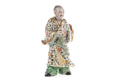 Lot 1282 - A CHINESE CERAMIC FIGURE OF AN IMMORTAL HOLDING A PEACH