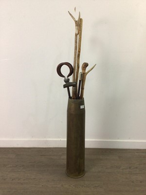 Lot 119 - A BRASS SHELL, WALKING STICKS AND CANES