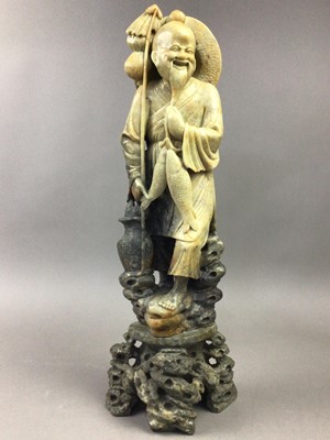 Lot 299 - A SOAPSTONE FIGURE OF A FISHERMAN AND TWO OTHER FIGURES