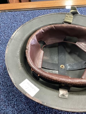 Lot 27 - A BRITISH ARMY IN NORTHERN IRELAND INERT RUBBER BULLET ROUND, AND A BRODIE HELMET
