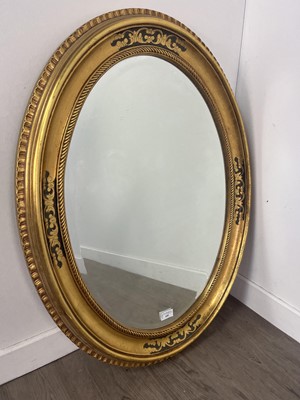 Lot 600 - AN OVAL WALL MIRROR