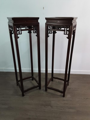 Lot 1162 - A PAIR OF TALL CHINESE HARDWOOD STANDS