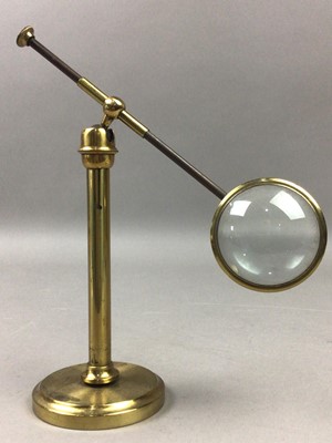 Lot 212 - A BRASS MAGNIFYING GLASS ON STAND