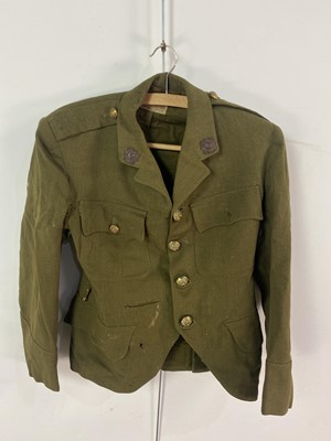 Lot 39 - A WWII JACKET, TWO KILTS, MILITARY BADGES AND AN ACME SCOUTS WHISTLE IN A LEATHER SUITCASE