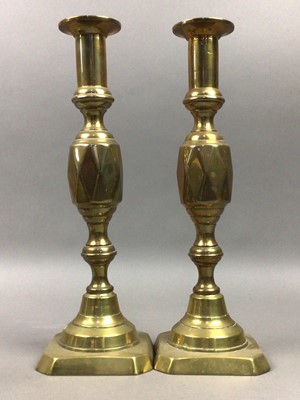 Lot 666 - TWO PAIRS OF BRASS CANDLESTICKS, AND A MANTEL CLOCK