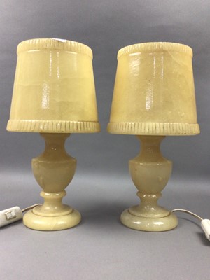 Lot 256 - A PAIR OF ONYX TABLE LAMPS AND A FAUX FUR COAT