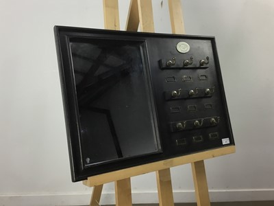 Lot 443 - AN EBONISED KEYRACK/MIRROR