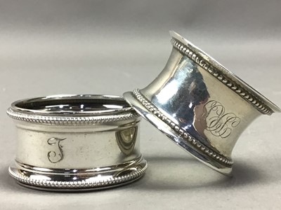 Lot 527 - A CASED SILVER PUSHER WITH SPOON AND EIGHT SILVER NAPKIN RINGS