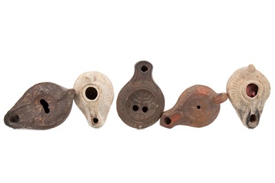 Lot 77 - A GROUP OF FIVE ANCIENT ROMAN TERRACOTTA OIL LAMPS