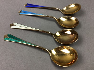 Lot 24 - A CASED SET OF FOUR SILVER GILT AND HARLEQUIN ENAMEL TEASPOONS