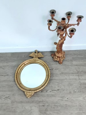 Lot 519 - A CIRCULAR WALL MIRROR IN A GILT PAINTED FRAME AND A CANDELABRUM