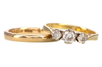 Lot 529 - A DIAMOND THREE STONE RING AND A WEDDING BAND