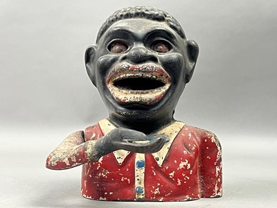 Lot 396 - A NOVELTY MONEY BANK AND A DOLL