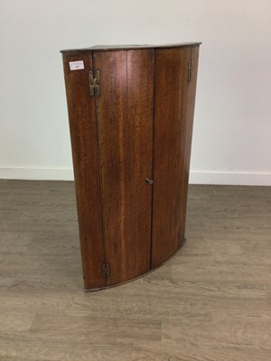 Lot 305 - A GEORGIAN OAK BOW FRONT CORNER CUPBOARD