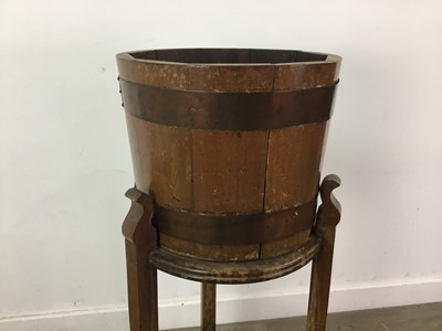 Lot 404 - AN OAK AND COPPER BOUND BARREL PLANTER ON STAND