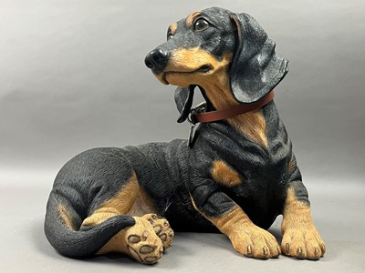 Lot 492 - A RESIN FIGURE OF A RESTING DOG