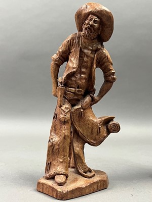 Lot 499 - A PAIR OF CARVED WOOD FIGURES OF COWBOYS