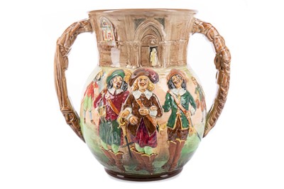 Lot 856 - CHARLES NOKE AND HARRY FENTON FOR ROYAL DOULTON, A THREE MUSKETEERS LOVING CUP