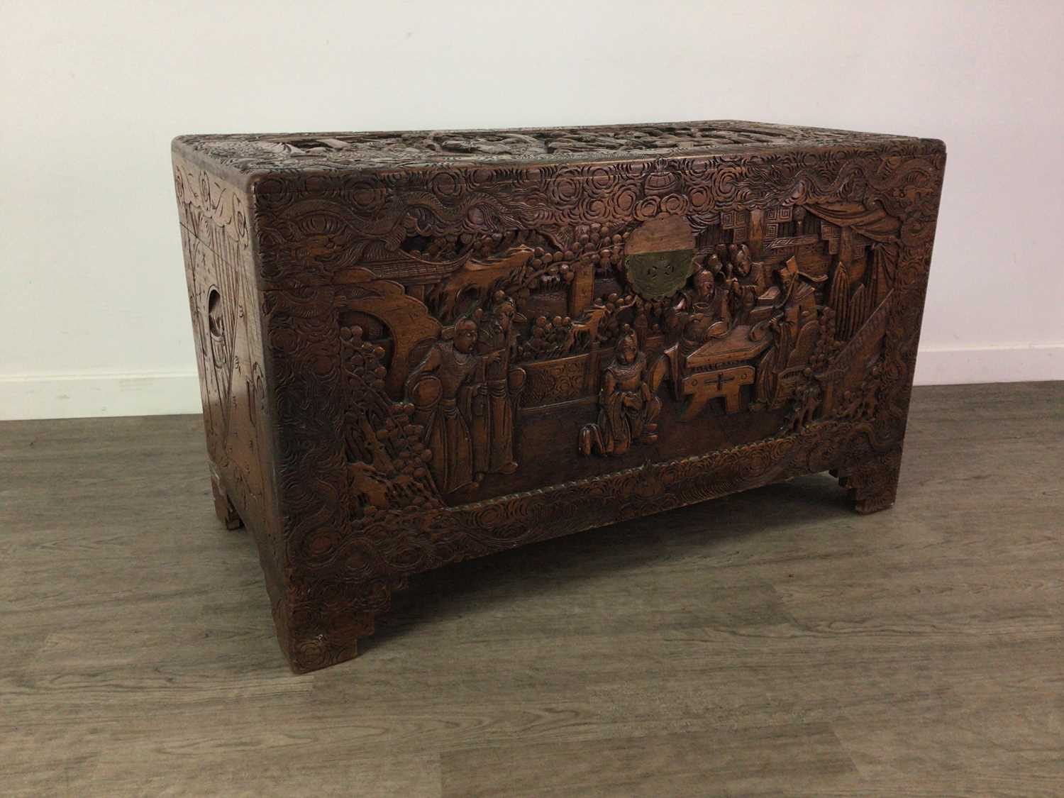 Lot 93 - A HEAVILY CARVED CHINESE HARDWOOD BLANKET CHEST
