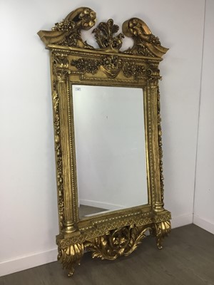 Lot 885 - A LARGE GILT WALL MIRROR IN THE ROCOCO TASTE