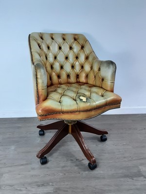 Lot 435 - A YELLOW LEATHER BUTTON BACK SWIVEL CHAIR