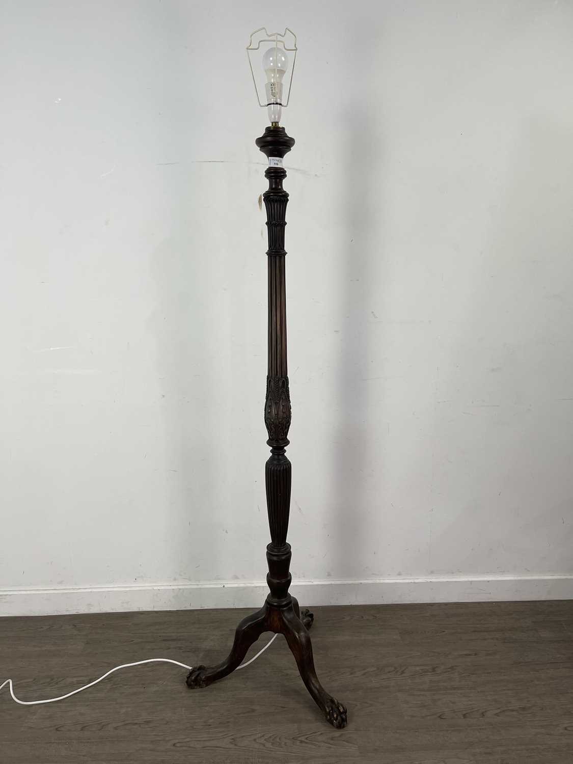 Lot 558 - A CARVED STANDARD LAMP