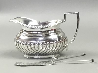 Lot 572 - A SILVER OBLONG PART FLUTED MILK JUG AND TWO BUTTER KNIVES