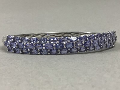 Lot 602 - A TANZANITE BANGLE