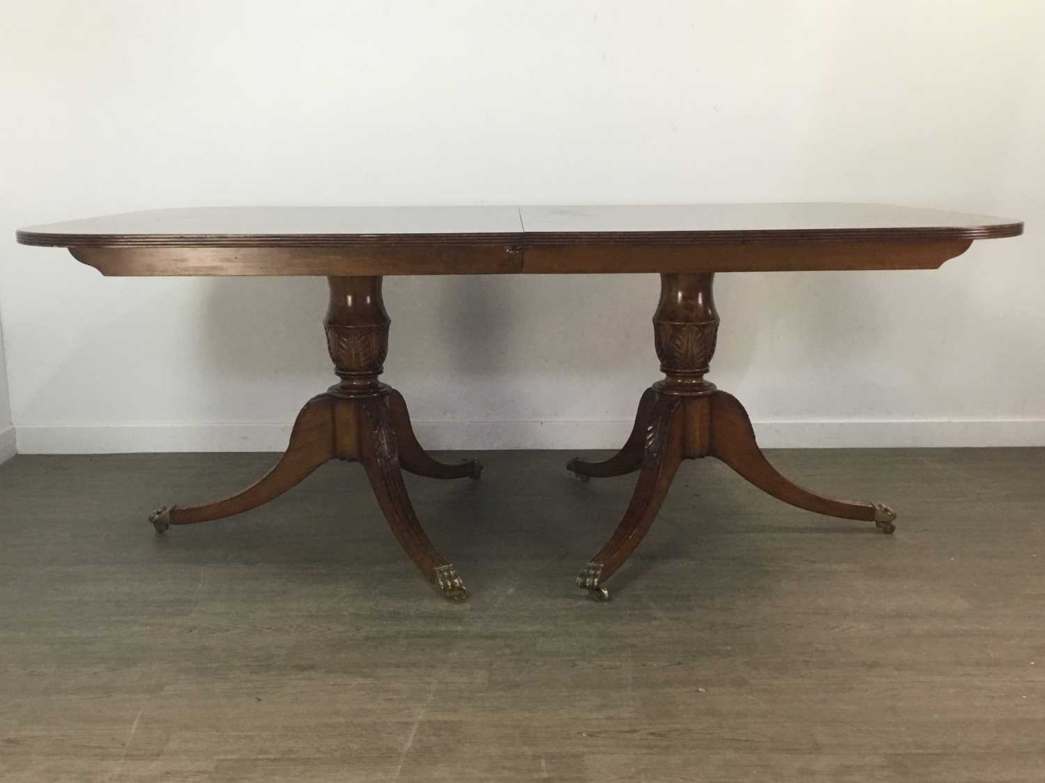 Lot 890 - A GOOD QUALITY REPRODUCTION WALNUT TWIN PEDESTAL DINING TABLE AND TEN CHAIRS