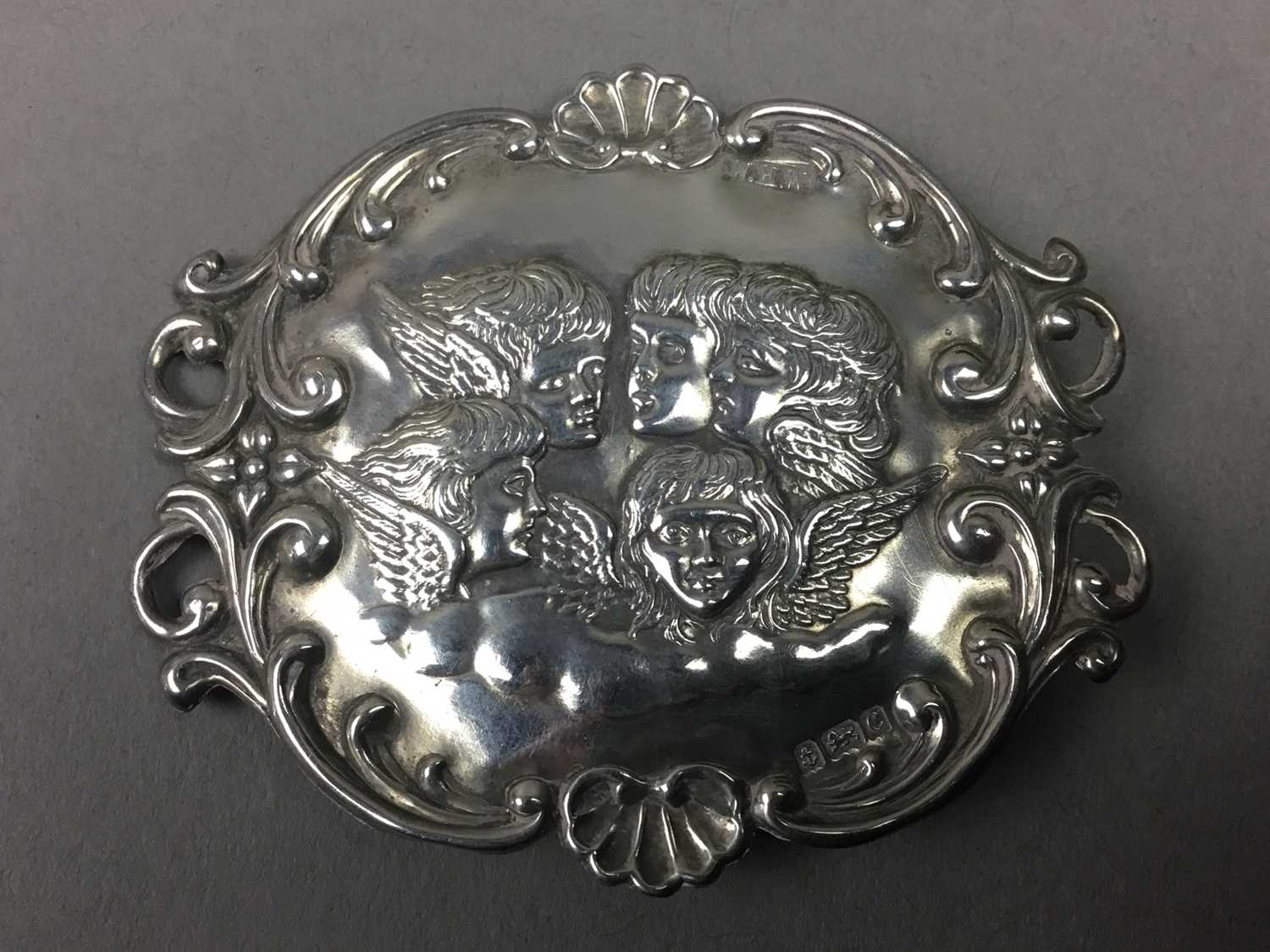 Lot 10 - A SILVER BROOCH DEPICTING REYNOLD'S ANGELS, ALONG WITH PLATED BELT AND SPOON