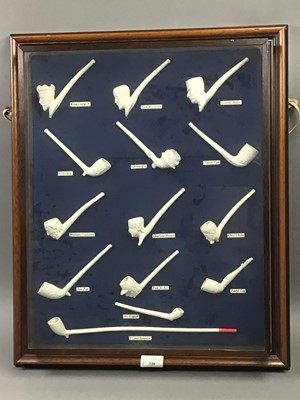 Lot 338 - A COLLECTION OF CLAY PIPES IN A GLAZED DISPLAY FRAME