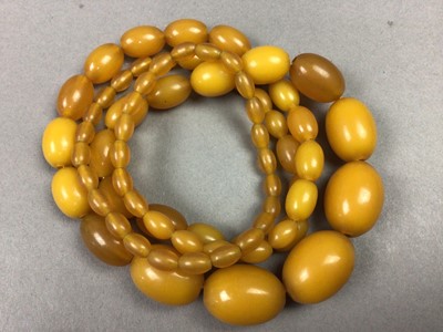 Lot 515 - THREE SETS OF GRADUATED AMBER COLOURED BEADS