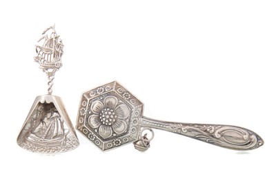 Lot 126 - PORTUGUESE SILVER RATTLE AND A WHITE METAL CADDY SPOON