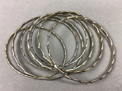 Lot 63 - ELEVEN SILVER AND WHITE METAL BANGLES