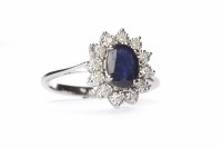 Lot 72 - SAPPHIRE AND DIAMOND CLUSTER RING the central...