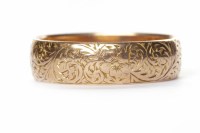Lot 87 - ENGRAVED WEDDING BAND with engraved scrollwork...