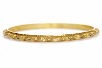 Lot 247 - TWENTY TWO CARAT GOLD BANGLE with a scalloped...