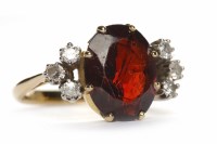 Lot 249 - GARNET AND DIAMOND RING the oval garnet of...