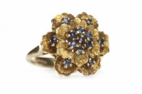 Lot 356 - EIGHTEEN CARAT GOLD SAPPHIRE FLORAL MOTIF RING...