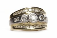 Lot 365 - DIAMOND DRESS RING set with three graduated...