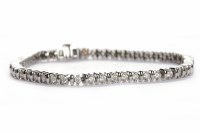 Lot 407 - DIAMOND LINE BRACELET set with round brilliant...