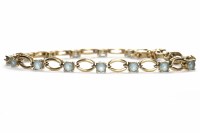 Lot 434 - FOURTEEN CARAT GOLD GEM SET BRACELET set with...